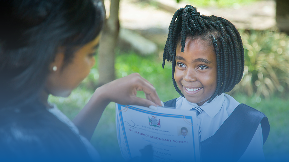 Student receiving a Certificate of Achievement in Zambia